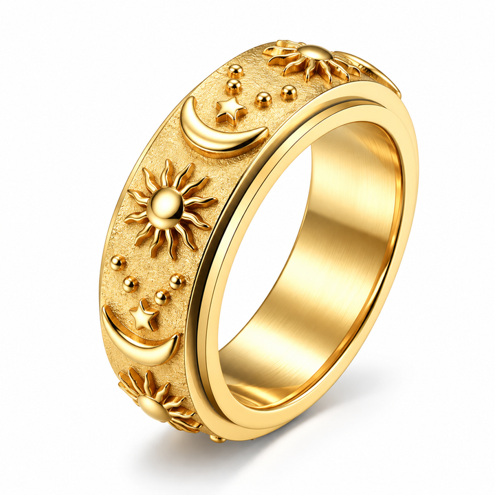 Gold celestial spinner ring with raised sun moon and star motifs