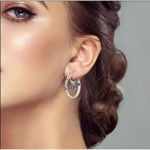 Model wearing silver celestial moon hoop earring