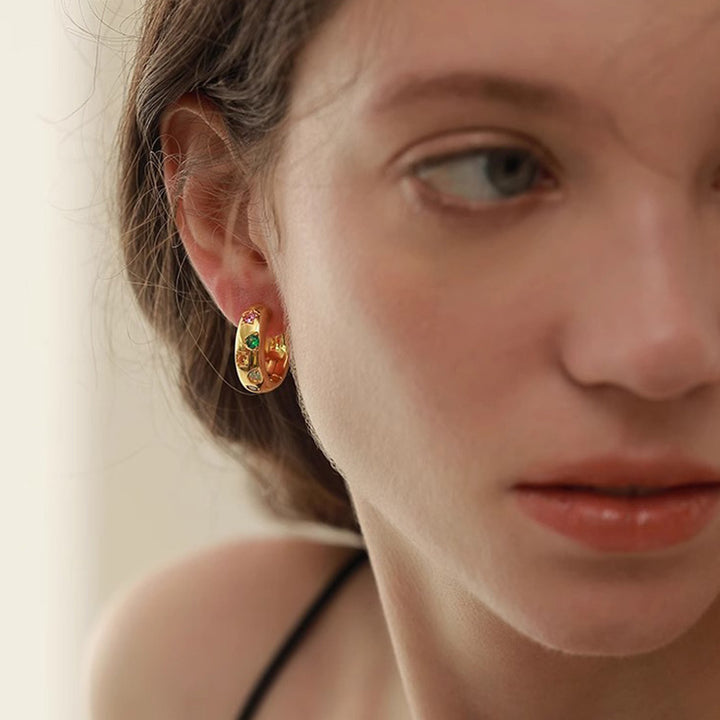 Model wearing gold Color Pop Huggie Hoop Earrings