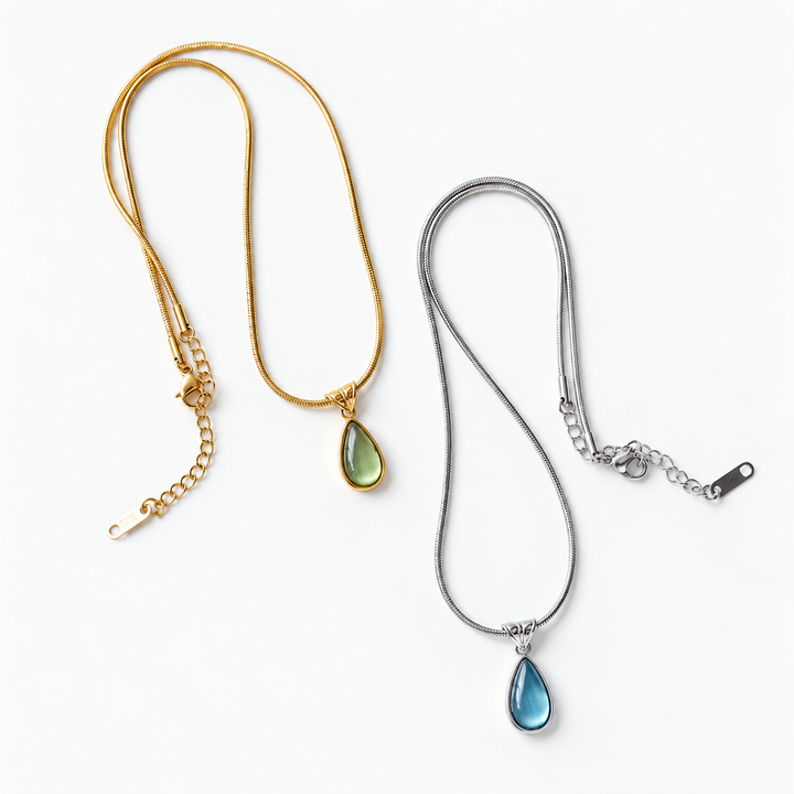 Crystal drop pendant necklaces in gold with green crystal and silver with blue crystal