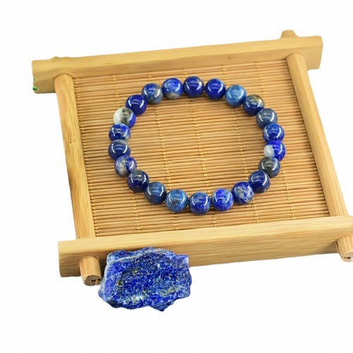 Blue lapis bracelet on a bamboo display