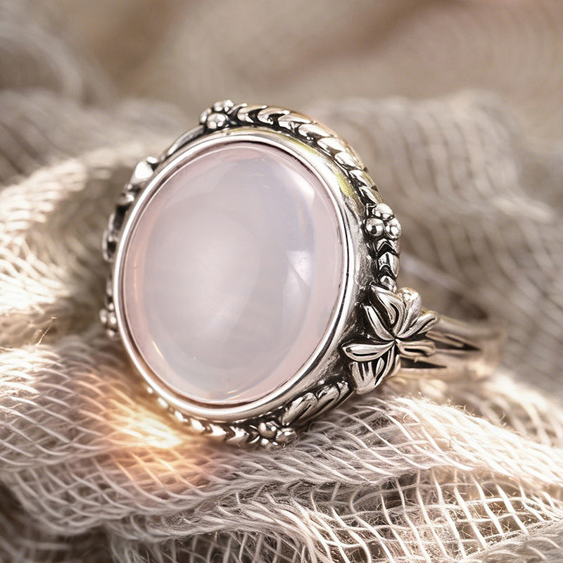 Silver floral moonstone ring on textured fabric