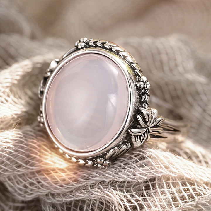 Silver floral moonstone ring on textured fabric