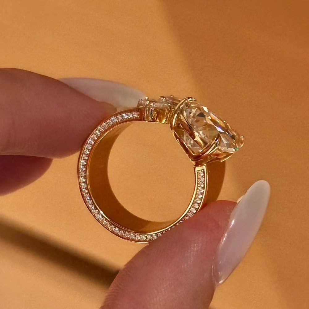 Side view of gold pear-cut floral open ring showing stone setting