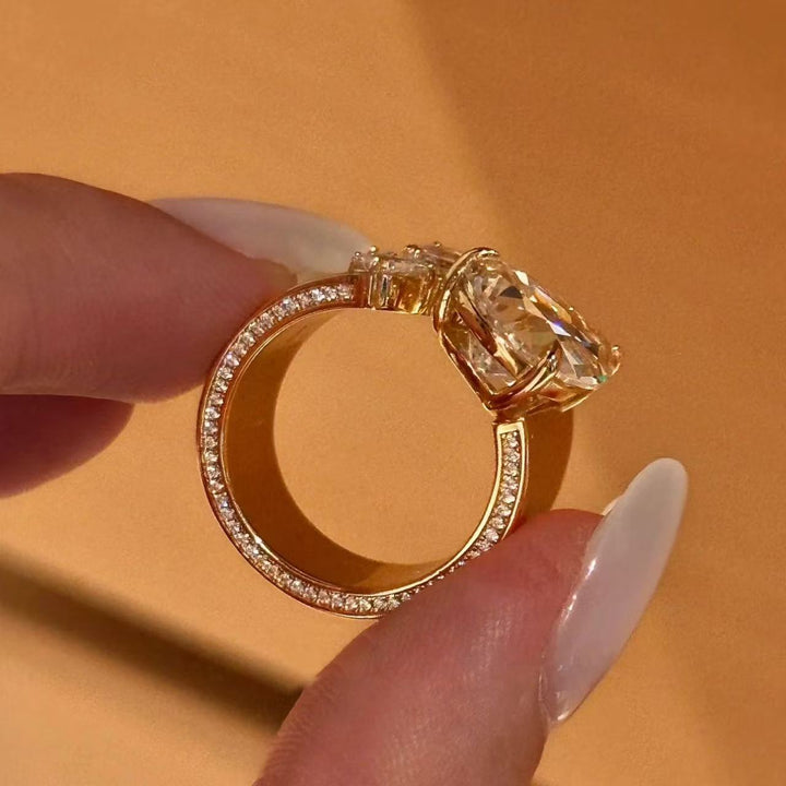 Side view of gold pear-cut floral open ring showing stone setting