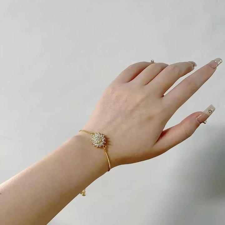 Gold-tone sunflower slider bracelet worn on the wrist