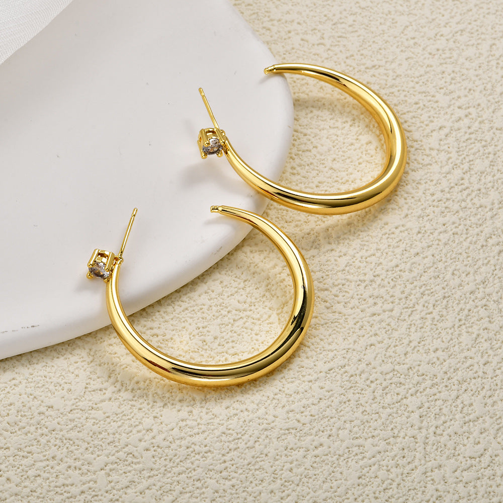 Pair of gold sculpted crescent hoop earrings