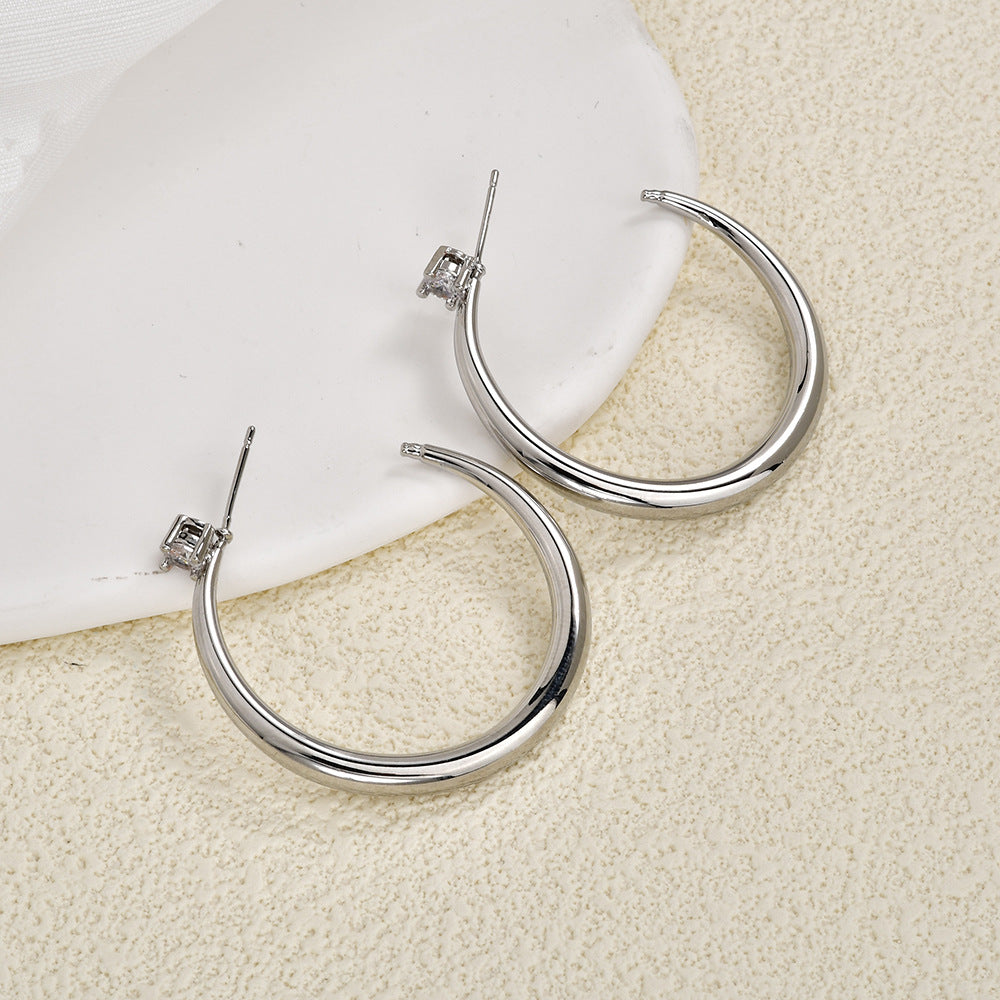 Pair of silver sculpted crescent hoop earrings