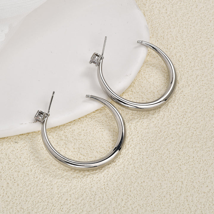 Pair of silver sculpted crescent hoop earrings