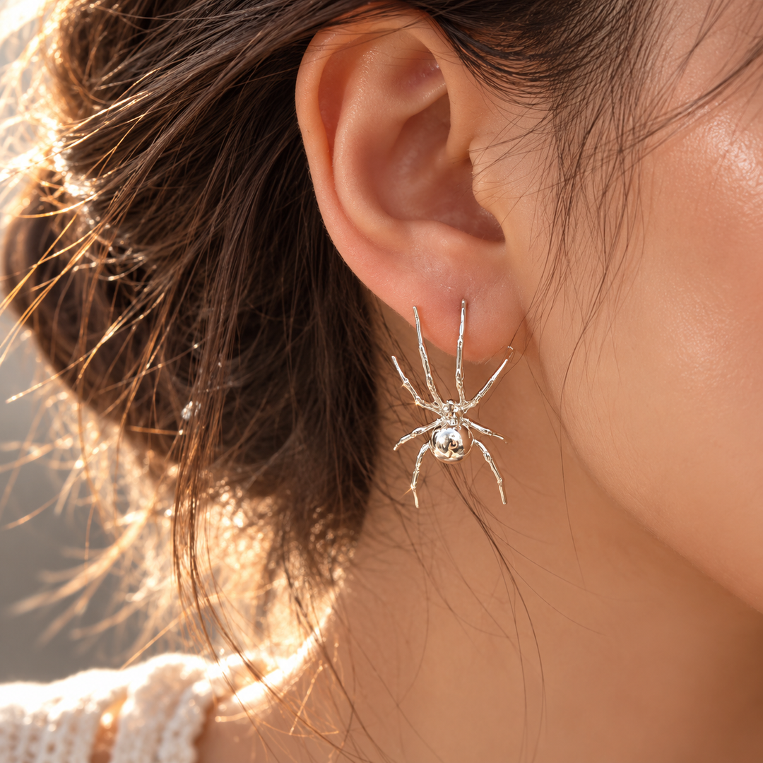 Model wearing a silver spider-shaped earring