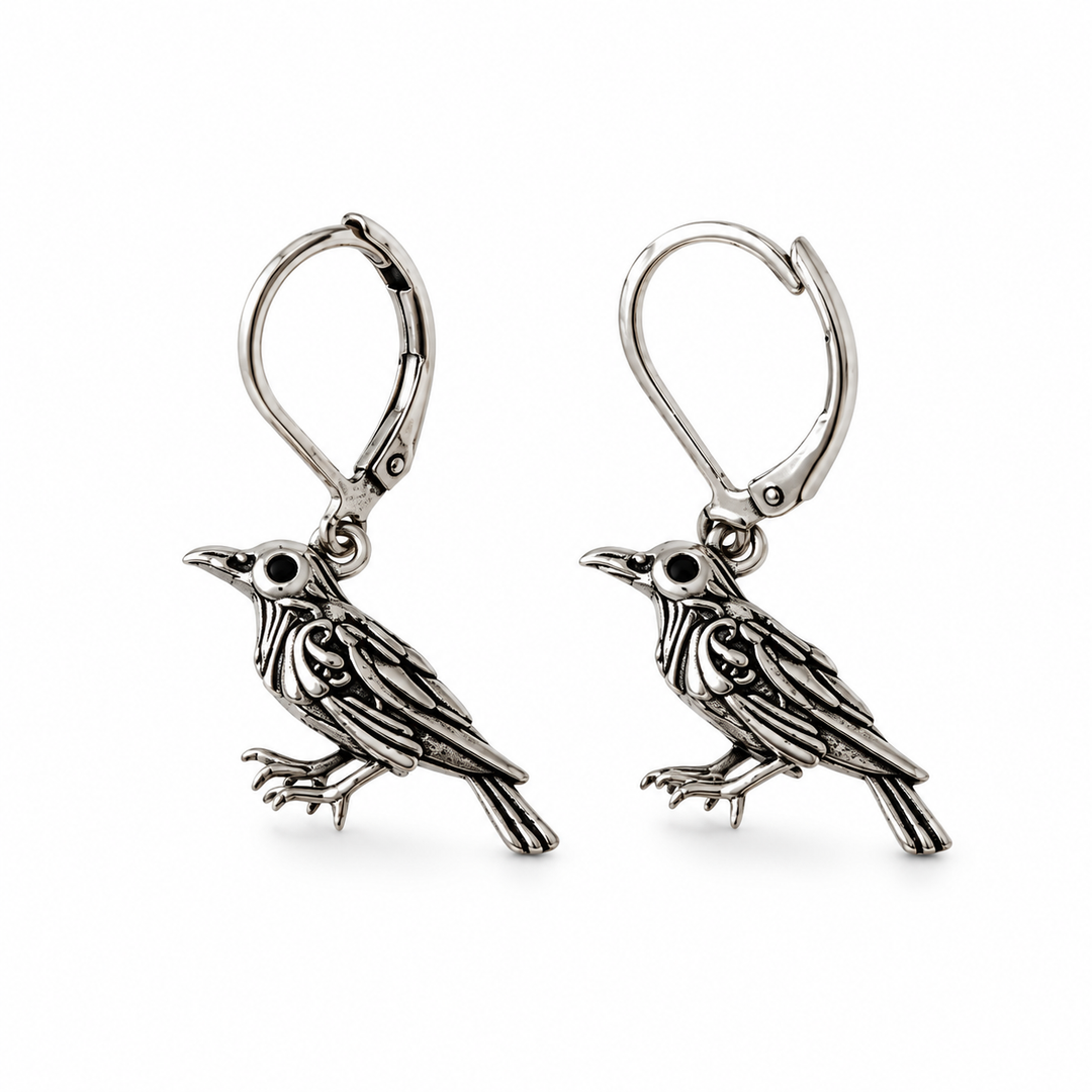 Silver vintage raven drop earrings on white background